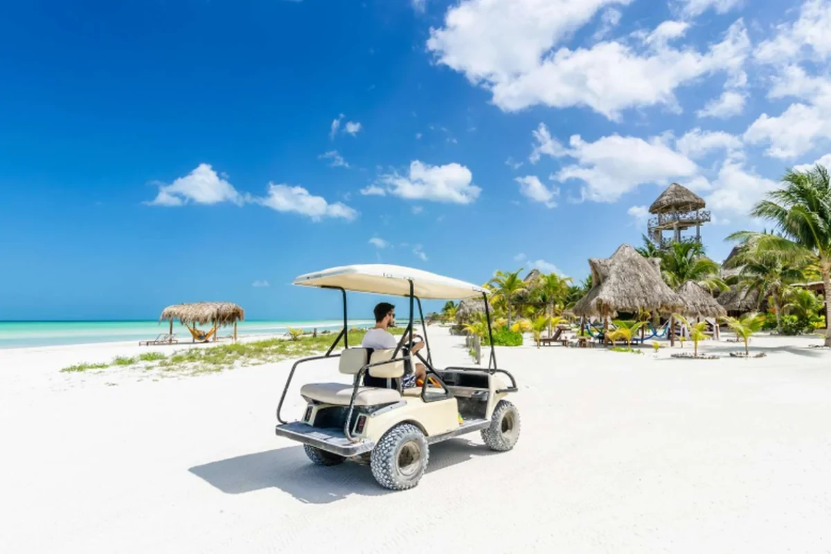 Il golf cart sulla sabbia davanti alle palapas di Holbox